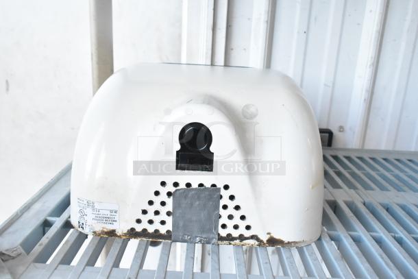 Three Xlerator XL-W white metal wall-mounted hand dryers, 110/120 volts, 1 phase, visible wear and rust on the bottom edge.