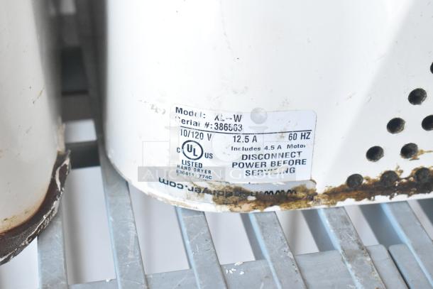 Three Xlerator XL-W white metal wall mount hand dryers, 110/120 volts, used condition with visible wear and rust on base.