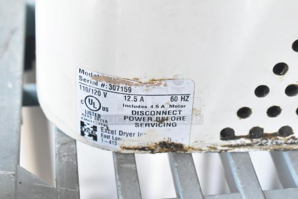 3 Xlerator XL-W hand dryers, white metal, wall mount, 110/120V, 1 Phase, visible service label, weathered condition.