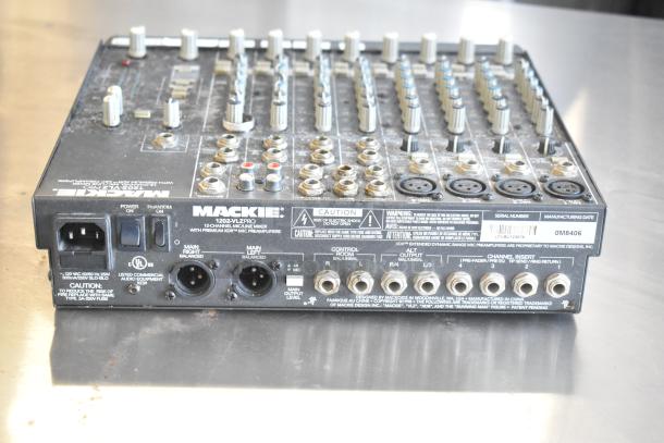 Mackie 1202-VLZ Pro 12-Channel Mixer, knobs and ports visible, in used condition with scratches, features XDR mic preamps.