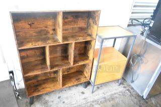 Two wooden items: a 6-cubby bookshelf with a rustic finish and a wood-pattern 2-tier stand with a door, both in good condition.