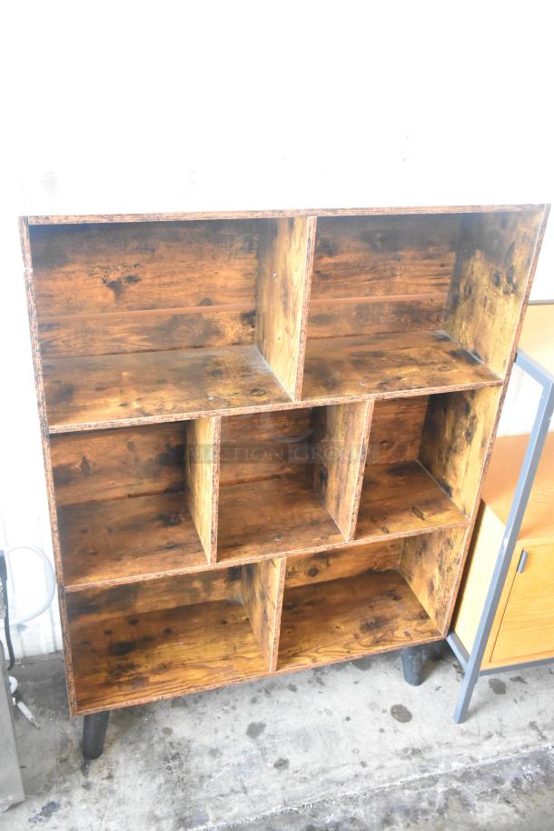 Wooden bookshelf with six open compartments, rustic finish, sturdy construction. Great for storage or display.