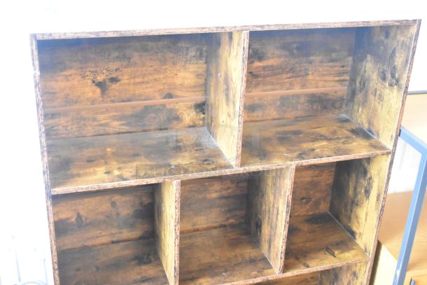 Wooden bookshelf with six compartments, featuring a rustic finish. Good condition, sturdy construction.