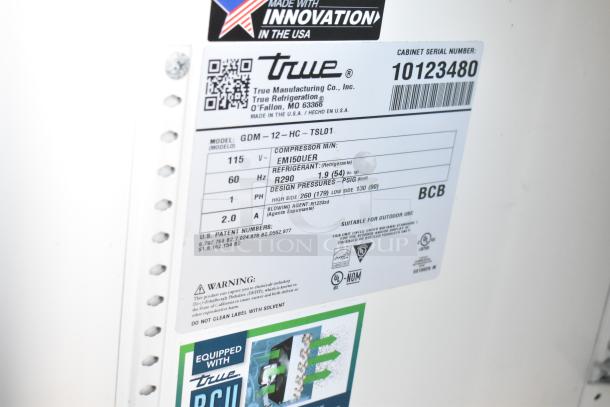 Label on a True GDM-12-HC commercial cooler, showing model, voltage (115 V), refrigerant (R290), and serial number.