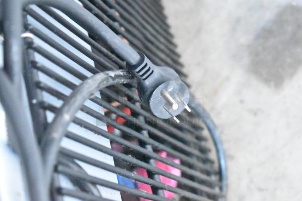 Close-up of a power cord plug for a 2021 True GDM-12-HC cooler, indicating 115 volts, 1-phase.