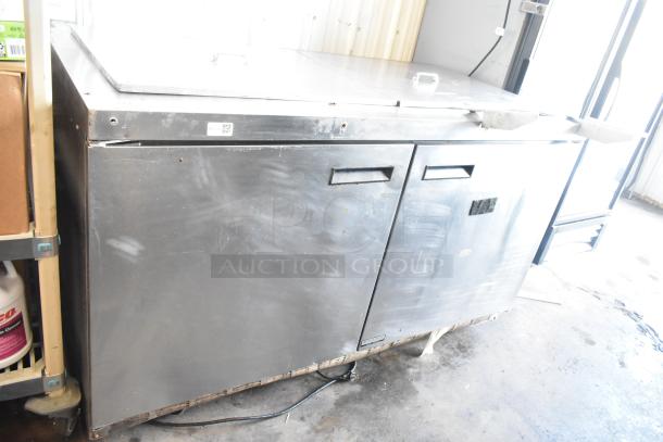 Delfield 4460N-24M-QZN stainless steel commercial prep table, 115 volts, 1 phase, showing some wear.