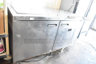 Delfield 4460N-24M-QZN stainless steel commercial prep table, 115 volts, 1 phase, showing some wear.