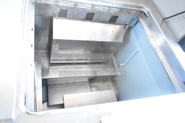 Delfield 4460N-24M-QZN stainless steel commercial prep table interior, suited for food prep, in fair condition. 115 volts, 1 phase.