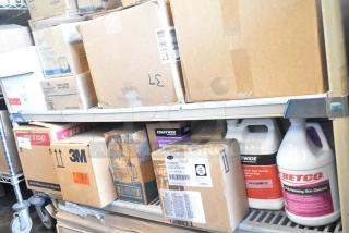 Tiered lot of cleaning products, featuring Betco Skin Cleanser, Coastwide Floor Cleaner, and Coastwide Lemon DC Plus. Boxes and bottles are shown on shelves, indicating bulk quantity.