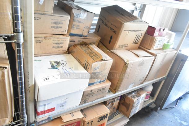 Tiered lot of assorted items, including Rubbermaid Auto Foam Refills, Aqua Sparkle Detergent, Dymo Label Printer in original packaging.