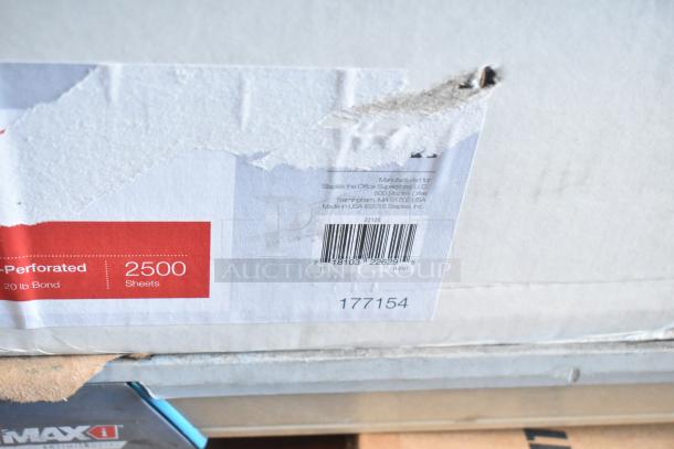 Tiered lot containing Staples 2500-sheet paper box, slightly damaged, and other items like Rubbermaid refills and Dymo label printer.