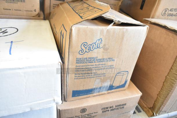 Stacked cardboard boxes containing Scott skin care products. Box label warns against heat, freezing. Not for retail.