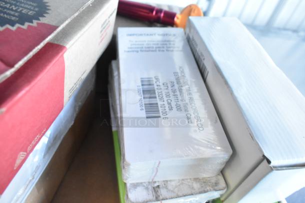 Tier lot with Rubbermaid Auto Foam refills, Aqua Sparkle detergent, and Dymo Label Printer, unopened, mixed packaging.