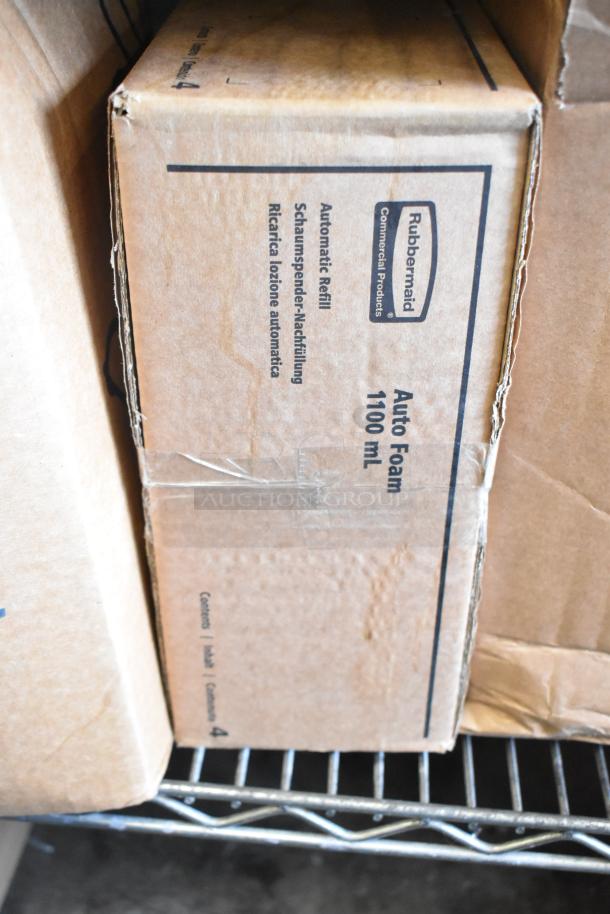 Cardboard box labeled "Rubbermaid Auto Foam 1100 mL" on metal shelf, showing signs of wear. Box contains automatic refill products.