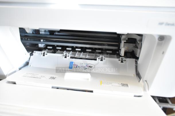 HP DeskJet 4255e printer with open compartment, showing cartridge instructions and visible internal mechanisms.