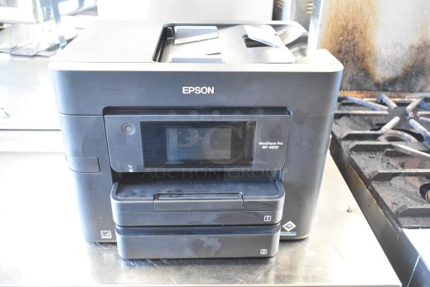 Epson WF-4830 Wireless All-in-One Inkjet Printer, featuring a touchscreen display, dual paper trays, in used condition.
