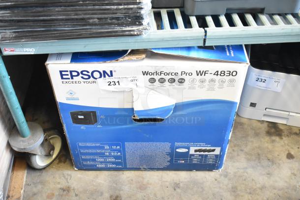 Epson WF-4830 Wireless All-in-One Inkjet Printer in original box. Box shows signs of wear with visible tears. Product features and specs displayed on the packaging.