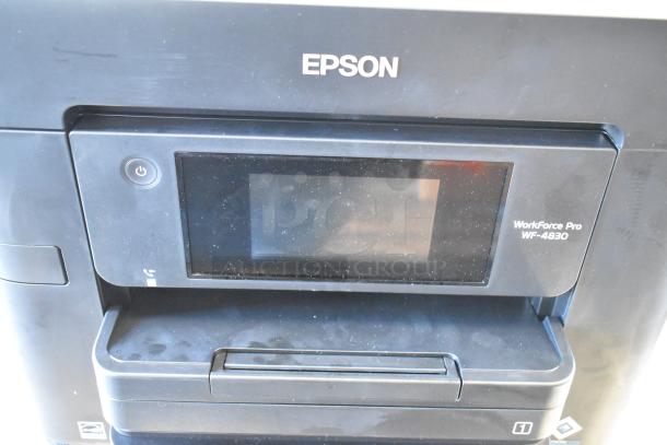 Epson WF-4830 Wireless All-in-One Inkjet Printer, black body, touchscreen interface. Used condition with some surface dust.