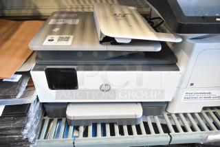 HP Countertop Printer Scanner Copier, white and gray, shows signs of use. HP logo on front. Model info on lid with QR code.