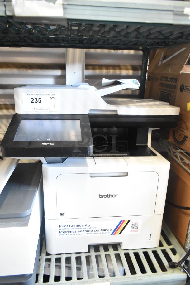 Brother MFC-L6810DW Countertop Printer, touchscreen, print, copy, scan, fax. Auction tag "235", good condition.