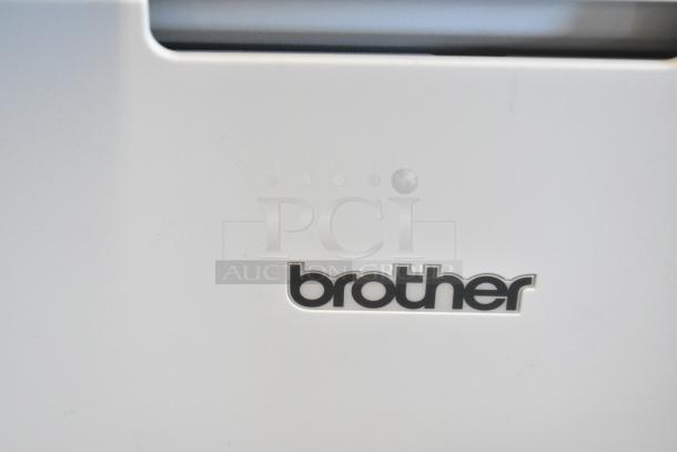 Brother MFC-L6810DW Countertop Printer, close-up of logo on white exterior, indicating brand.
