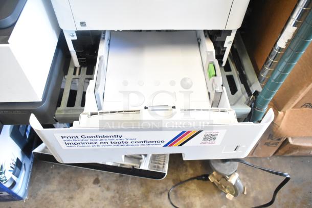 Brother MFC-L6810DW countertop printer with open paper tray, showing clean and well-maintained condition. "Print Confidently" label visible.