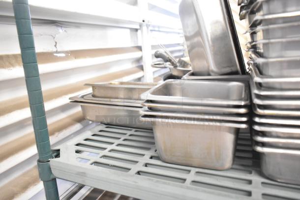 Lot of stainless steel and poly drop-in bins, used condition, assorted sizes, ideal for kitchen storage and organization.