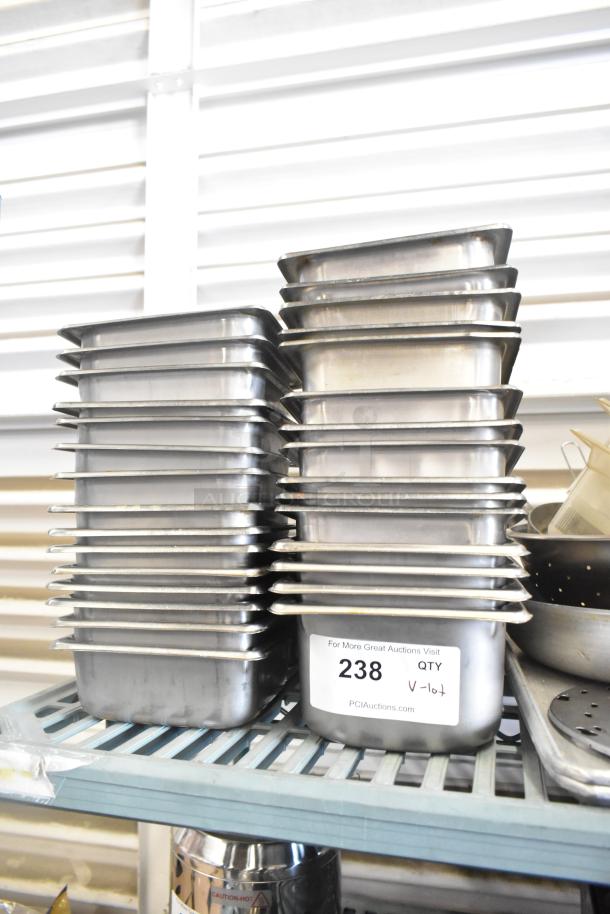 Lot of stainless steel and poly drop-in bins, stacked on a shelf. Label shows quantity 238 for auction.