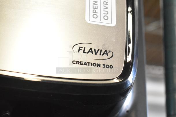 Flavia Creation 300 metal commercial countertop single-serve coffee brewer machine, 120 volts, logo visible.