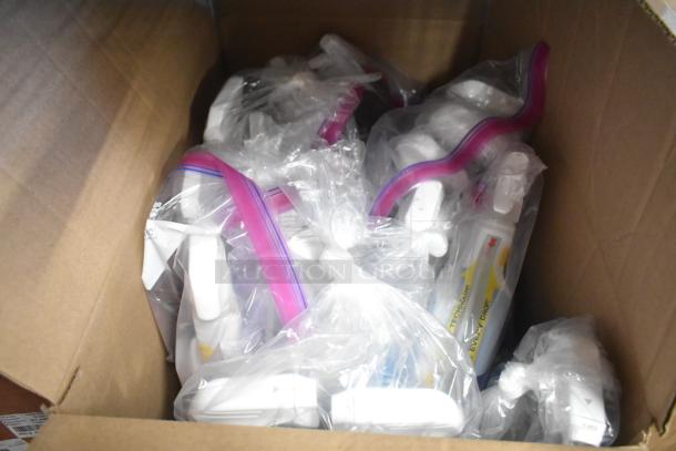 Box of assorted items including Clorox spray, grouped in plastic bags. Items are in new condition, various types.