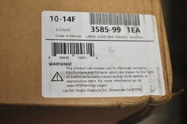 Cardboard box with label for Cal-Mil Plastic Products. Item: Large Condiment Bar with Pans. Warning of chemical exposure.