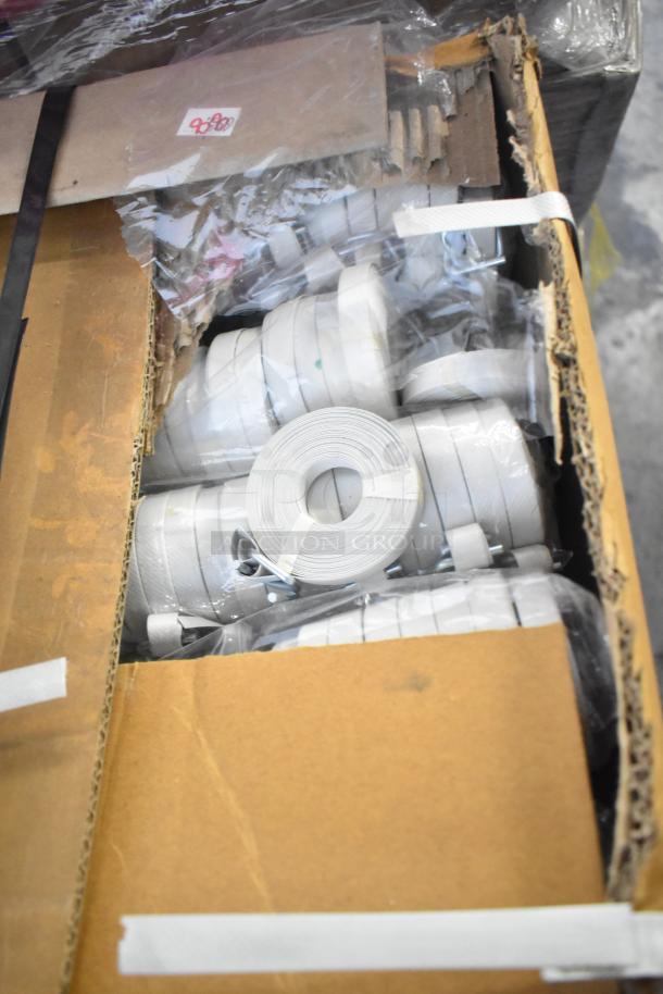 Cardboard box containing 18 brand new poly strapping rolls, slightly scratched and dented; sold at 18 times the bid.