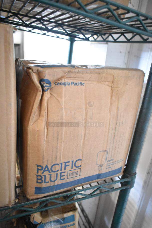 Three-tiered lot with boxes of Gojo green hand and body wash, Diversey Suma Blend detergent. Visible marks: Georgia-Pacific, Pacific Blue Ultra. Boxes show wear.