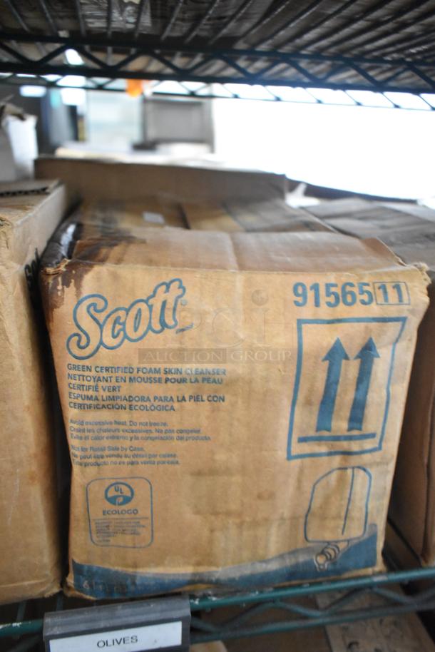 Boxes on a shelf, including Scott Green Certified Foam Skin Cleanser with visible EcoLogo certification. Packaging shows wear.