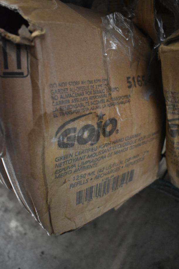 Three-tier lot of assorted boxes with Gojo Green Hand and Body Wash packaging. Boxes show wear, indicating storage or transportation usage.