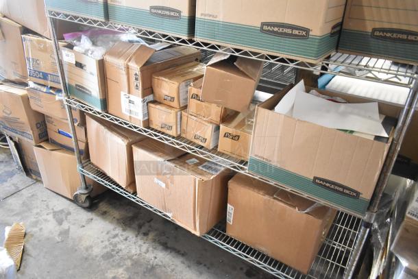 Two-tier metal shelving unit with assorted boxes, including Bankers Box, Purell, and other packaging, in a storage setting.