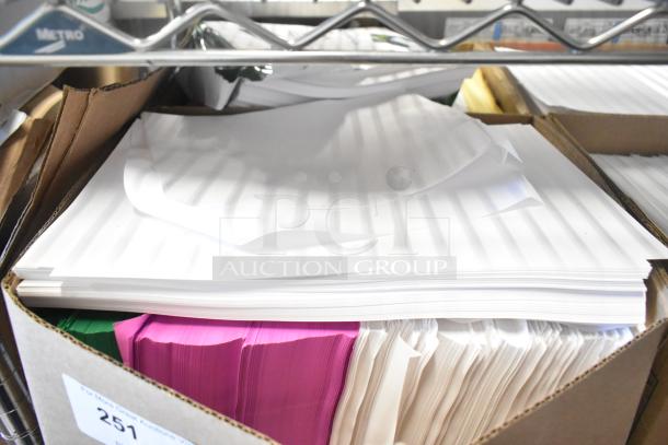 Cardboard box containing assorted paper stacks in white, pink, and green on a metal shelf, labeled "251" for auction.