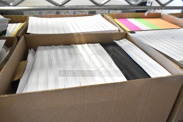 Box of assorted paper sheets in various colors, including white, pink, and green. Condition appears new.