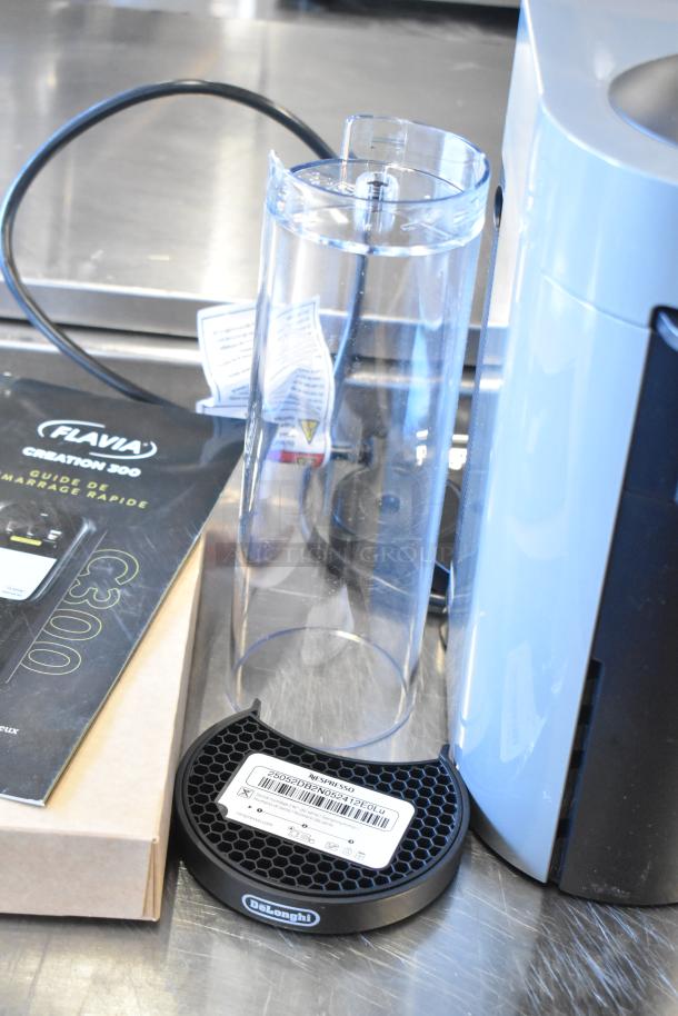 DeLonghi ENV150GY Nespresso VertuoPlus coffee machine, includes water tank and base. Condition appears good.