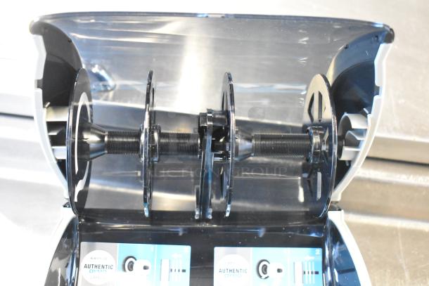 Dymo LabelWriter 450 Twin Turbo printer, dual spools, open lid showing interior mechanisms, "authentic Dymo labels" visible.