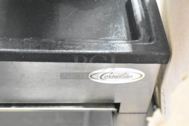 Stainless steel Cornelius beverage machine, 6 flavors, on drop-in ice bin. 115V, 1 phase. "Cornelius" label visible.
