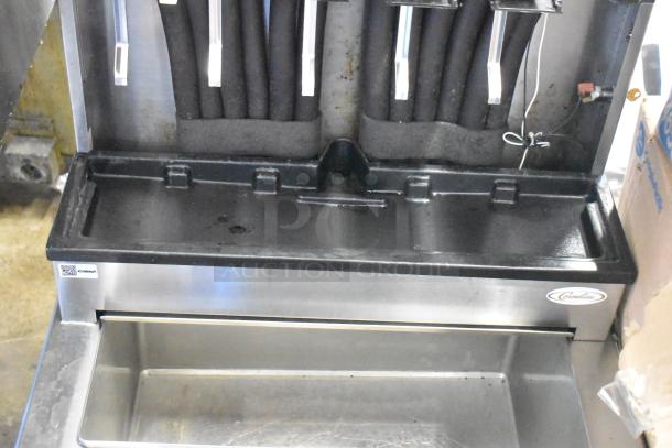 Stainless steel commercial 6 flavor beverage machine on Cornelius ice bin, 115 volts, 1 phase, showing dispensing area.