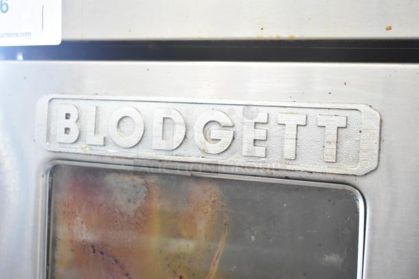 Blodgett Zephaire 200 stainless steel convection oven with view-through doors, metal racks, and casters, showing logo detail.