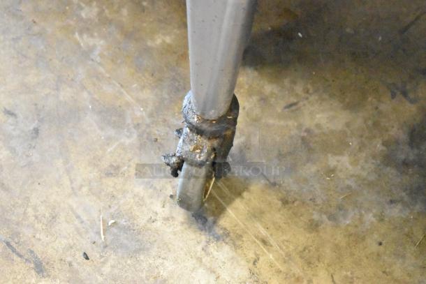 Close-up of a commercial caster wheel on a Blodgett Zephaire 200 convection oven, showing signs of use.