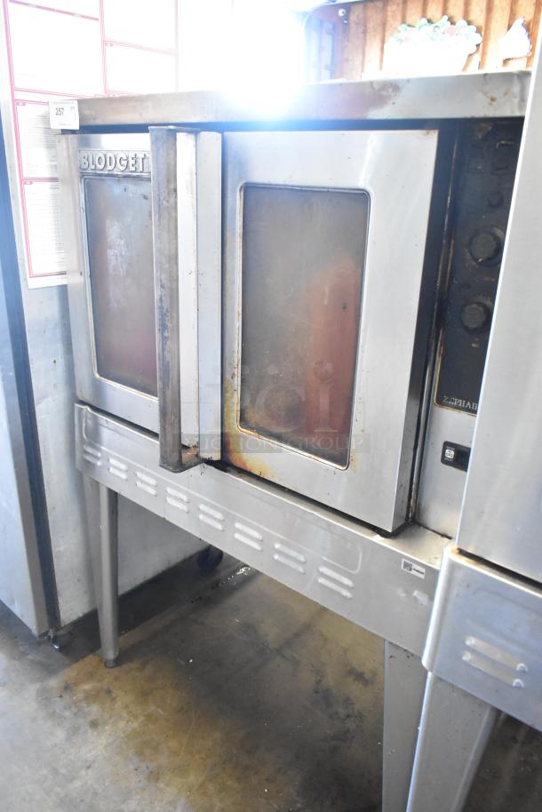 Blodgett Zephaire stainless steel convection oven, view-through doors, metal racks, thermostatic controls, metal legs, casters.