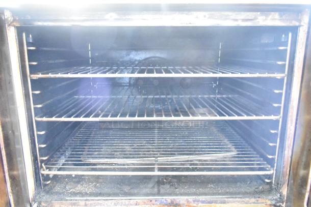 Blodgett Zephaire stainless steel commercial convection oven with view-through doors, metal racks, and commercial casters.