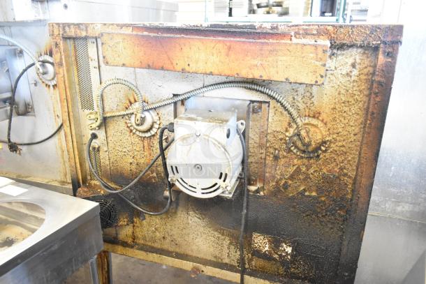 Back view of a Blodgett Zephaire convection oven showing exposed wiring and a motor, indicating wear and rust.