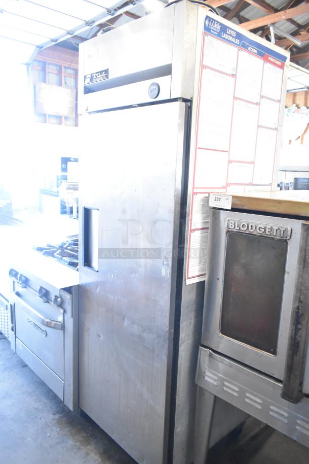 True TM-24 stainless steel commercial cooler, single door, metal rack, casters, 115V, 1 Phase. Visible label: True.