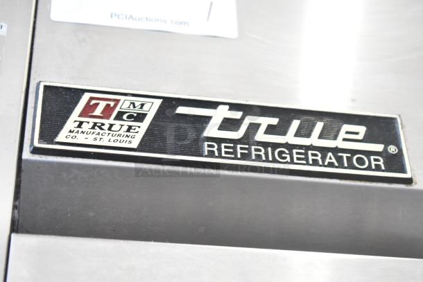 True TM-24 commercial single door cooler, stainless steel, on casters, 115V, metal rack, True logo visible.