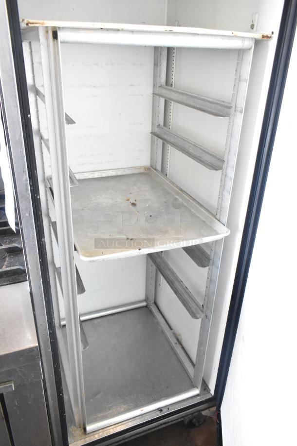 True TM-24 stainless steel commercial reach-in cooler, single door, metal rack, on casters, 115 volts, 1 phase, used condition.